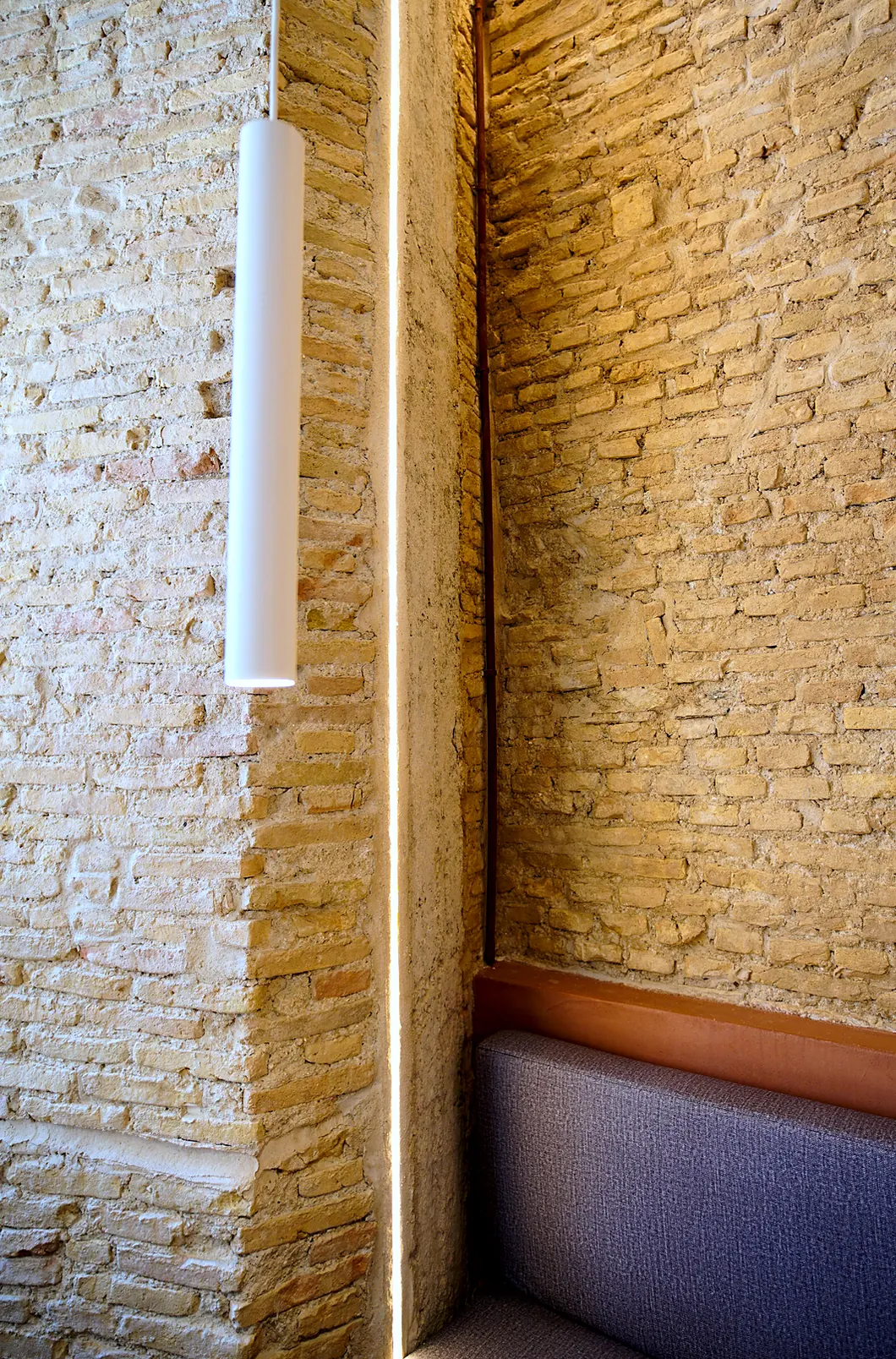 Corner with brick, concealed lighting and seating