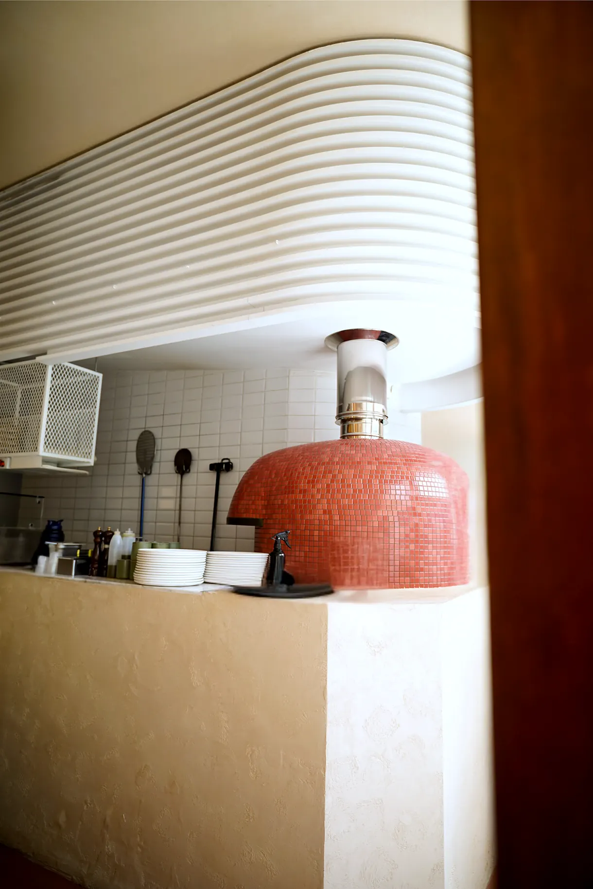The oven beneath the wave-shaped ceiling