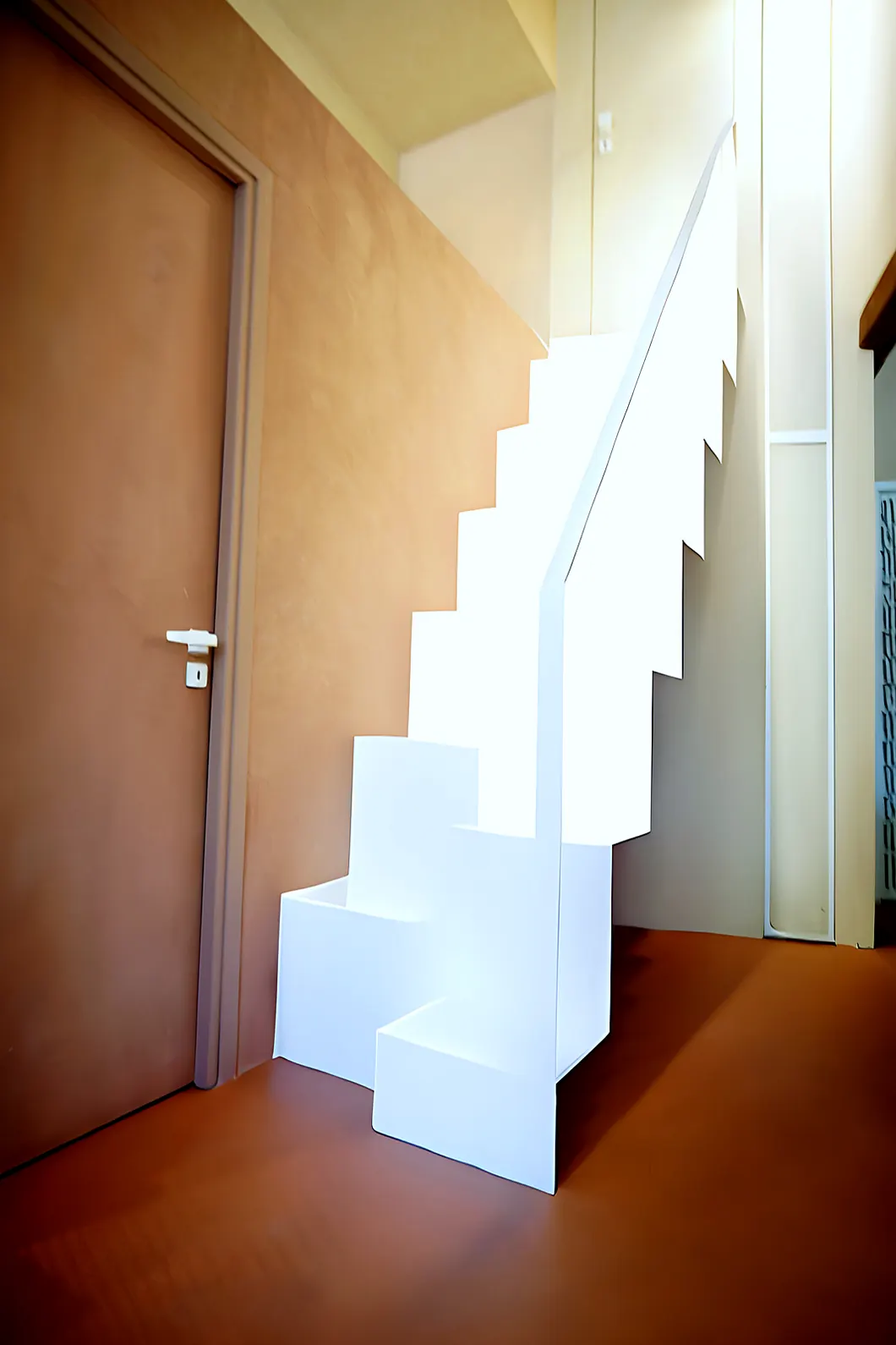 The white staircase by the door