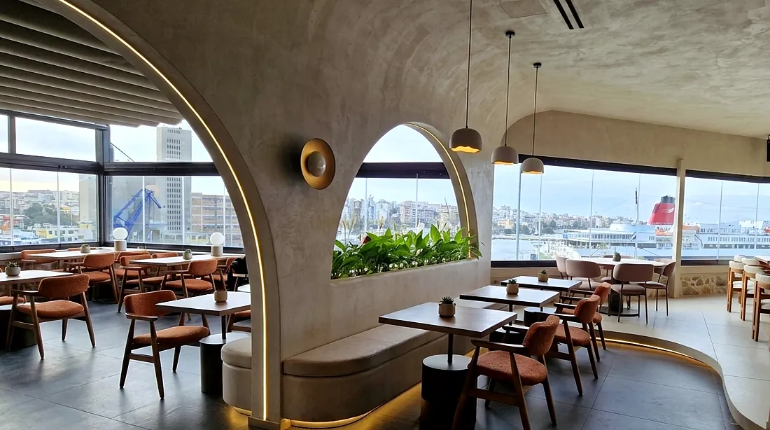 La Luna after: a dining room with arches, a textured ceiling and a view of the harbour