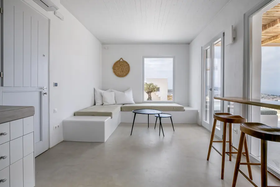 Momi Homes: Living room with a built-in sofa and microcement